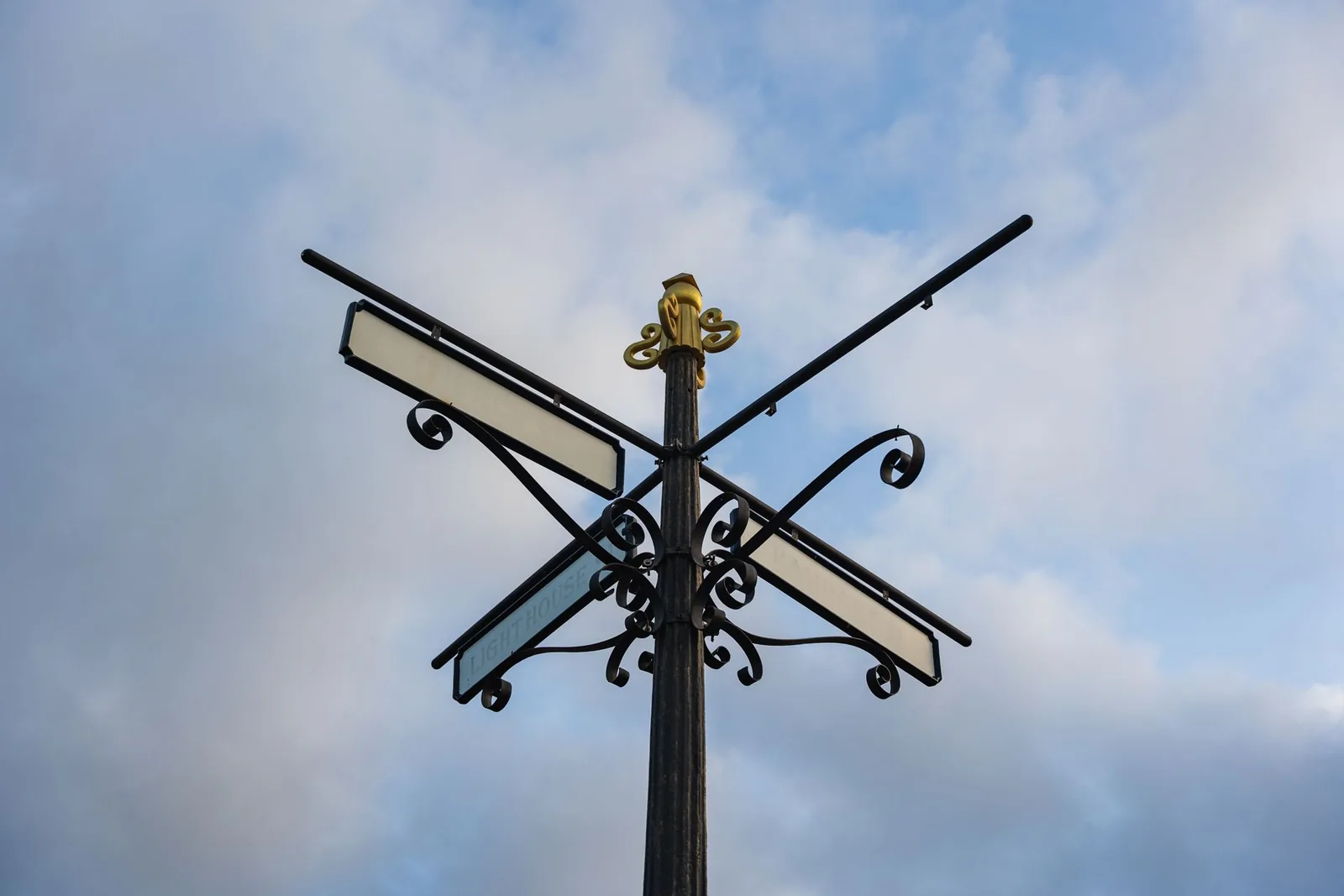 A signpost pointing in several directions at once against an open sky, standing in for two search surfaces that lead different ways.
