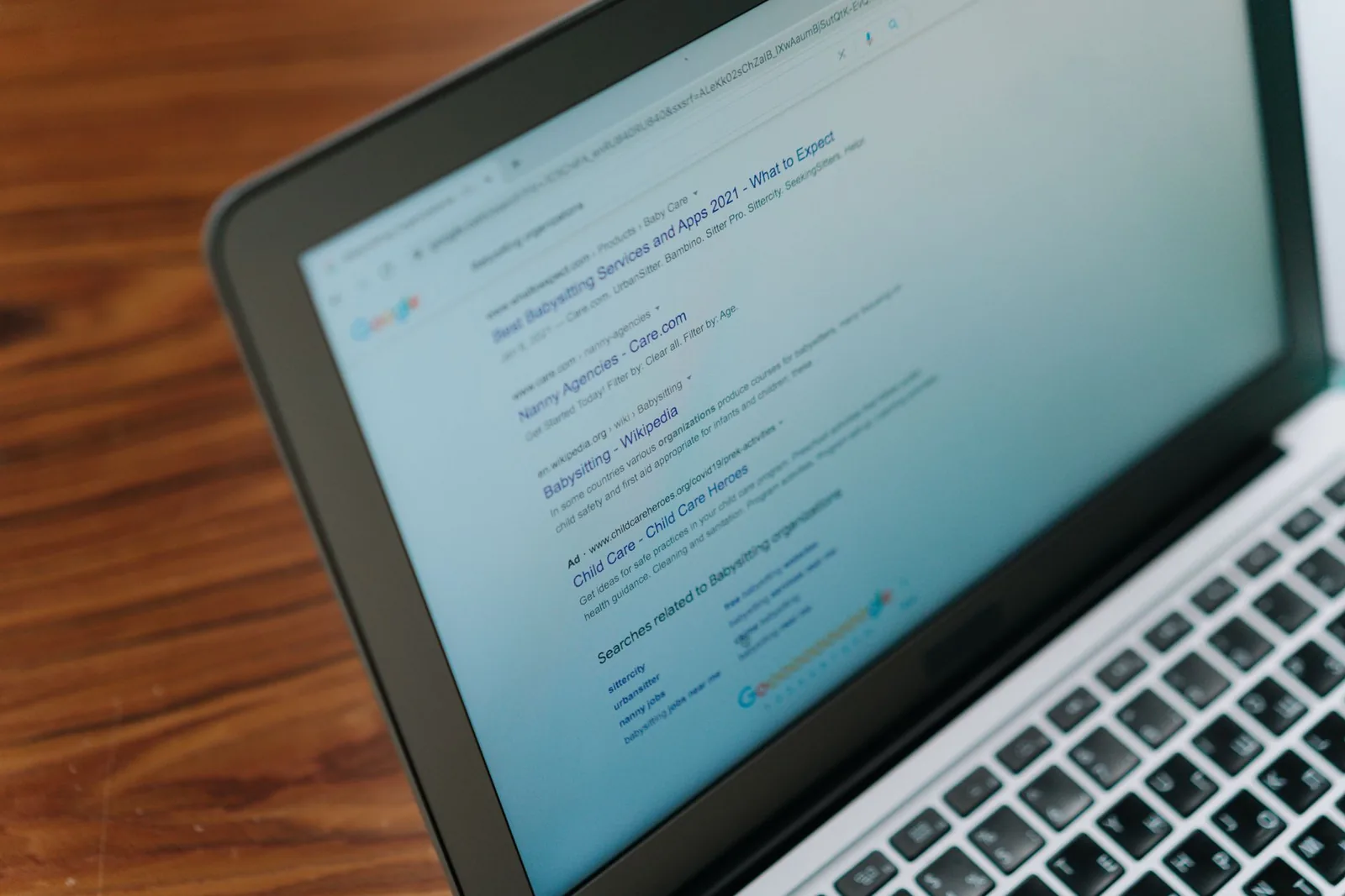 A laptop showing a page of search results, where an AI Overview appears above the ordinary links.