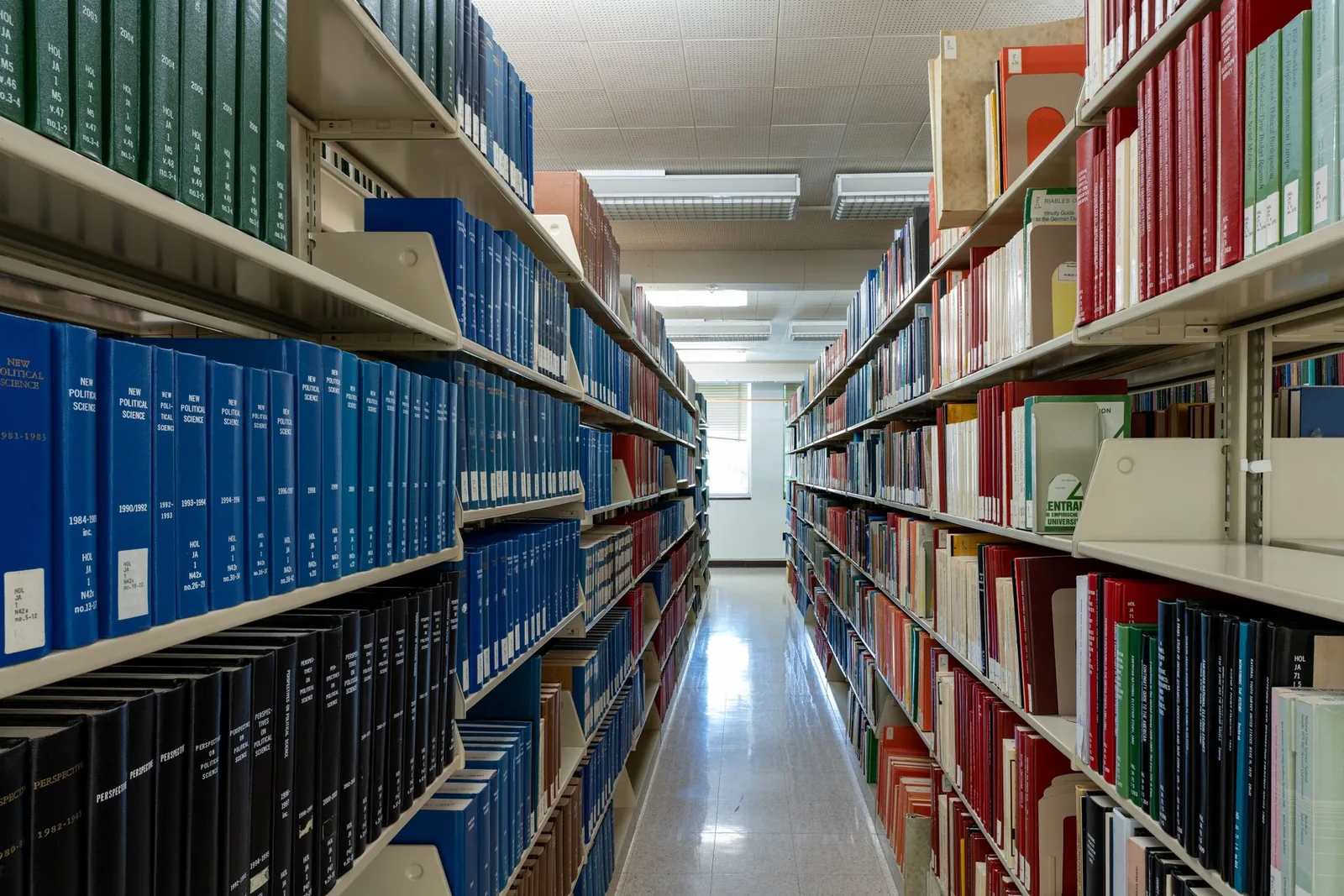Library shelves receding into the distance, standing in for the list of sources behind a cited answer.